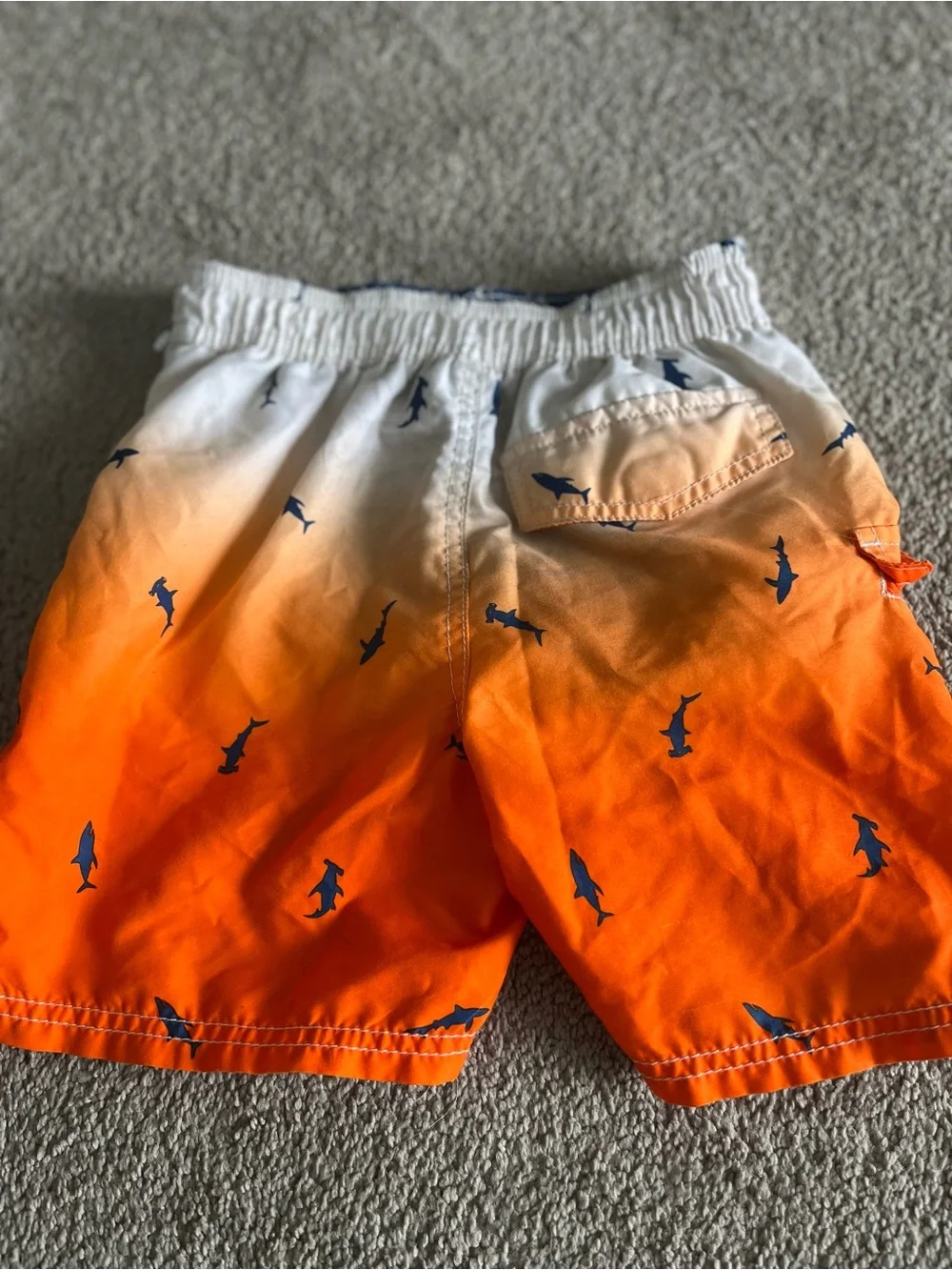 OshKosh B'gosh White to Orange Ombre Swim Trunks with Navy Shark Print